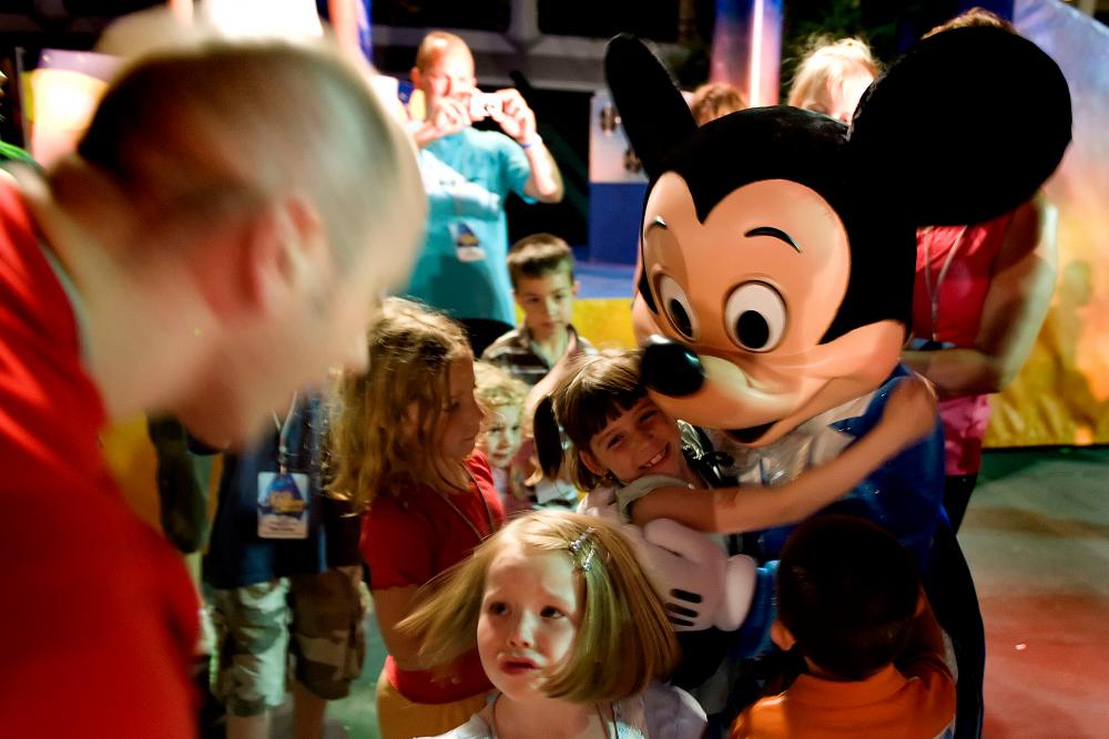 In this file park patrons meet Mickey Mouse during a special after hours event for Disney World’s “Year of a Million Dreams” give away, at Disney World’s Magic Kingdom in Orlando, Florida, May 7, 2008. — AFP