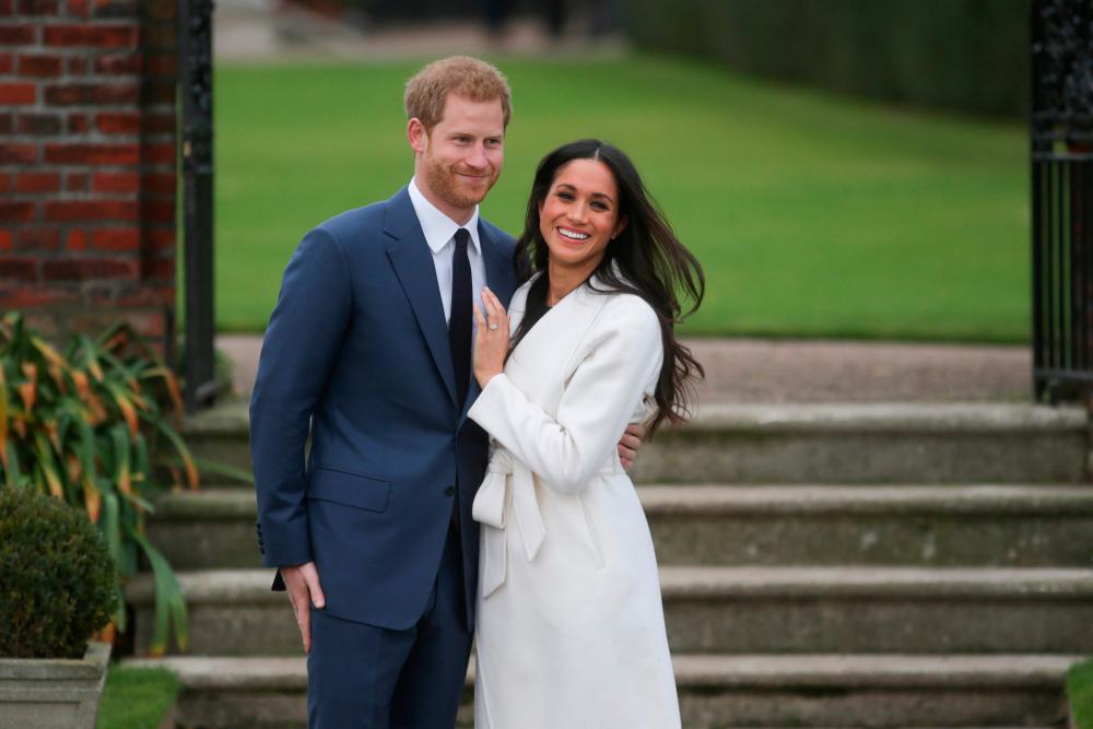 In this file photo taken on Nov 27, 2017 Britain’s Prince Harry and his fiancée US actress Meghan Markle pose for a photograph in the Sunken Garden at Kensington Palace in west London, following the announcement of their engagement. — AFP