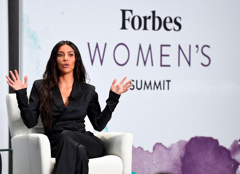 (FILES) In this file photo taken on June 13, 2017, Kim Kardashian speaks with Steve Forbes at the 2017 Forbes Women's Summit at Spring Studios in New York City. –AFP