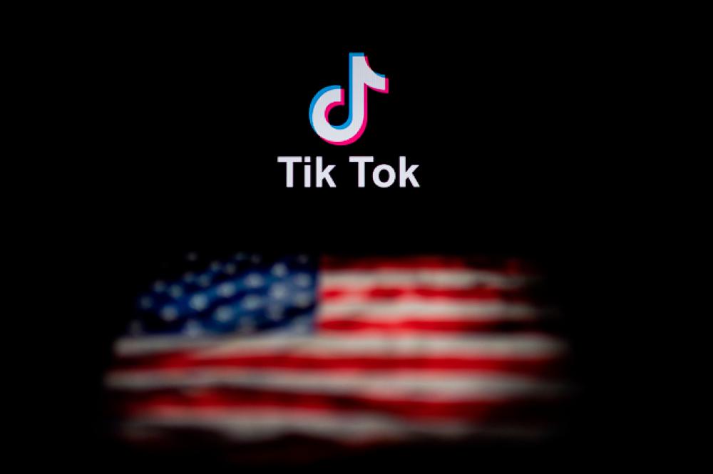 In this file photo illustration taken on September 14, 2020, shows the logo of the social network application TikTok and a US flag on the screens of two laptops in Beijing. — AFP
