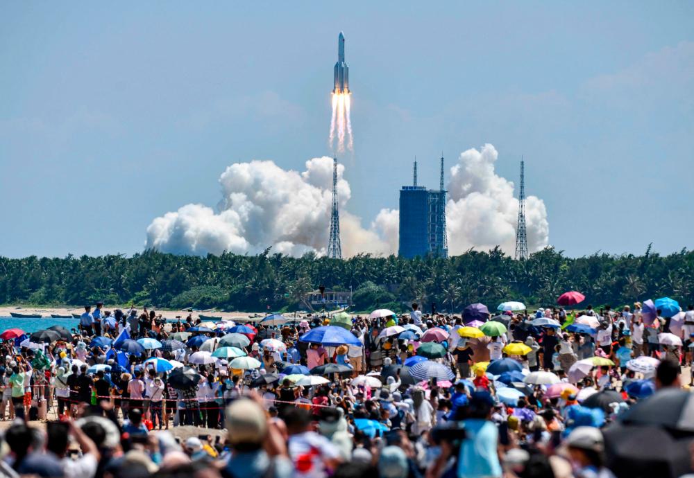 In this file photo taken on July 24, 2022, onlookers watch the launch of a rocket transporting China’s second module for its Tiangong space station from the Wenchang spaceport in southern China/AFPPix