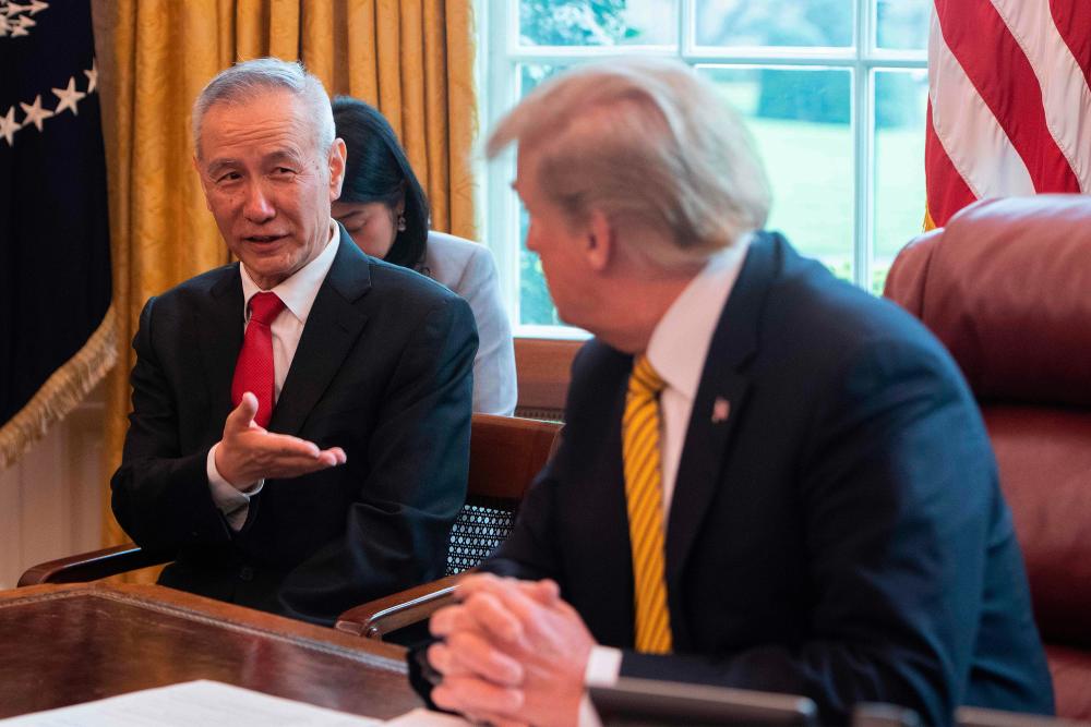 In this file photo taken on April 4, 2019 China's Vice Premier Liu He (L) speaks with US President Donald Trump during a trade meeting in the Oval Office at the White House in Washington, DC. - AFP