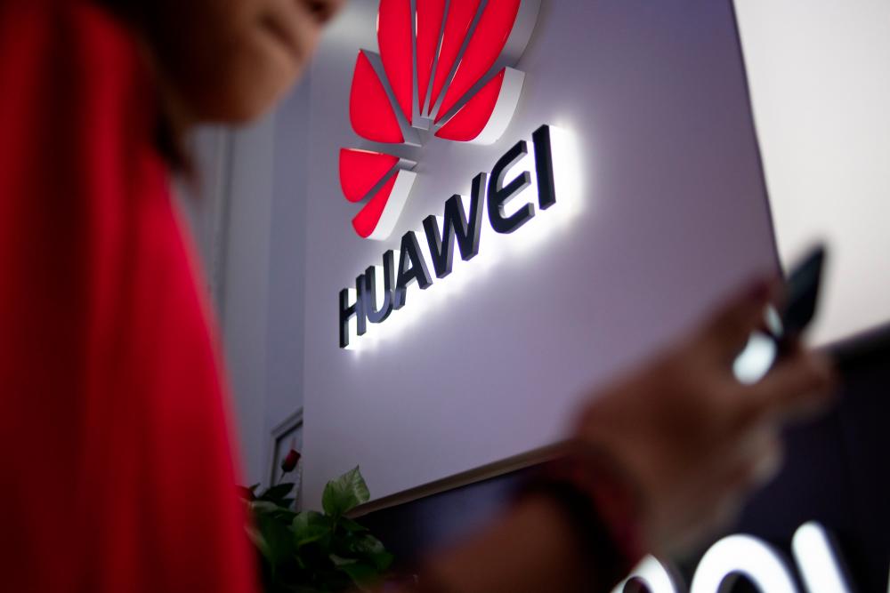 A Huawei logo is displayed at a retail store in Beijing. Chinese telecoms giant Huawei, which is subject to US sanctions over concerns about its ties to the government in Beijing, is planning to make major job cuts at its US operations, The Wall Street Journal reported on July 14, 2019. — AFP
