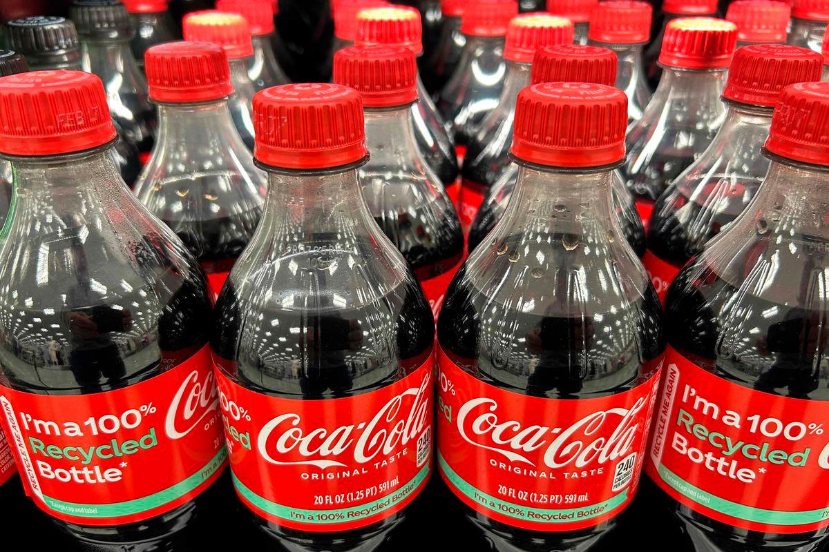 (FILES) Plastic bottles that read “100% Recycled Bottle” of Coca-Cola sit on the shelf at a store in Stevensville, Maryland, on March 25, 2025. Beverage giant Coca-Cola has agreed to use real cane sugar in its US production, President Donald Trump announced on July 16, 2025 on social media. Coca-Cola did not immediately confirm the ingredient shift- Photo by Jim WATSON / AFP