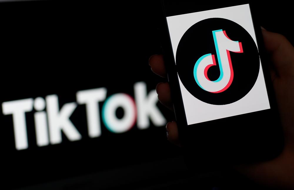 (FILES) In this file photo taken on April 13, 2020, the social media application logo, TikTok is displayed on the screen of an iPhone, in Arlington, Virginia. / AFP / Olivier DOULIERY
