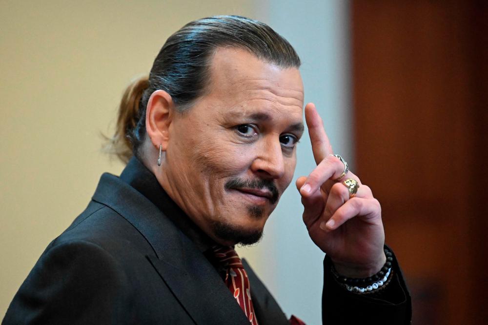 (FILES) In this file photo taken on May 3, 2022 US actor Johnny Depp looks on during a hearing at the Fairfax County Circuit Courthouse in Fairfax, Virginia. AFPPIX