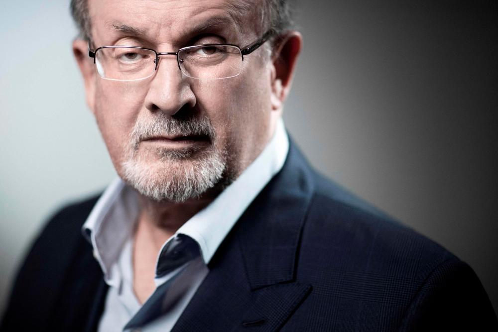 (FILES) In this file photo taken on September 10, 2018, British novelist and essayist Salman Rushdie poses during a photo session in Paris. AFPPIX