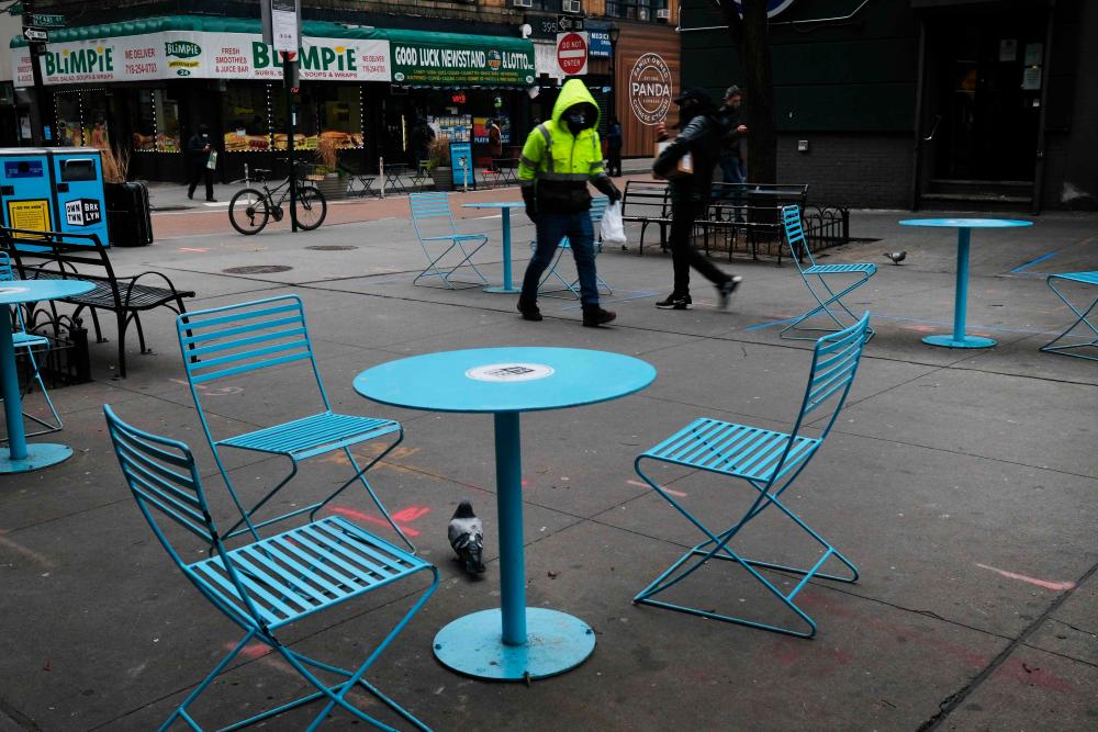 Empty tables sit outside restaurants in downtown Brooklyn in New York City. Out-of-control coronavirus infections are disrupting operations at businesses like restaurants, gyms and other establishments where crowds tend to gather, reducing hours for many workers and pushing others out of employment. – AFPPIX
