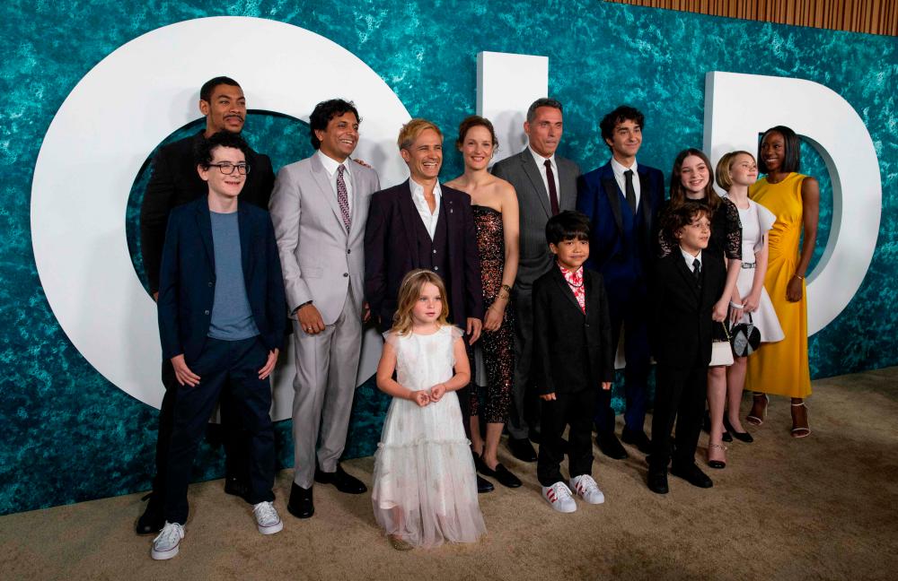 (FILES) In this file photo (L-R) Luca Faustino Rodriguez, Aaron Pierce, M. Night Shyamalan, Kylie Begley, Gael García Bernal, Vicky Krieps, Rufus Sewell, Kailen Jude, Alex Wolff, Nolan River, Alexa Swinton, Mikaya Kenzie Fisher and Nikki Amuka-Bird attend the New York premiere of “Old” at Jazz at Lincoln Center on July 19, 2021 in New York City. -AFP