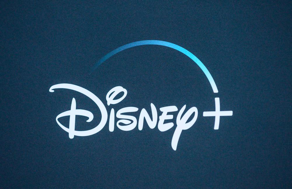 (FILES) In this file photo taken on November 13, 2019 the Disney+ logo is seen on the backdrop for the World Premiere of “The Mandalorian” at El Capitan theatre in Hollywood. Disney has added extended disclaimers to classics including “Peter Pan” and “Aristocats” on its streaming platform to warn viewers that the films contain derogatory stereotypes about minorities. / AFP / Nick Agro