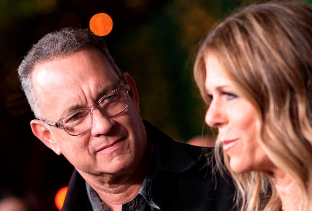 In this file photo taken on November 07, 2018 actors Tom Hanks (L) and his wife actress/singer Rita Wilson attend “JONI 75: A Birthday Celebration” Live at the Dorothy Chandler Pavilion in Los Angeles. / AFP / VALERIE MACON