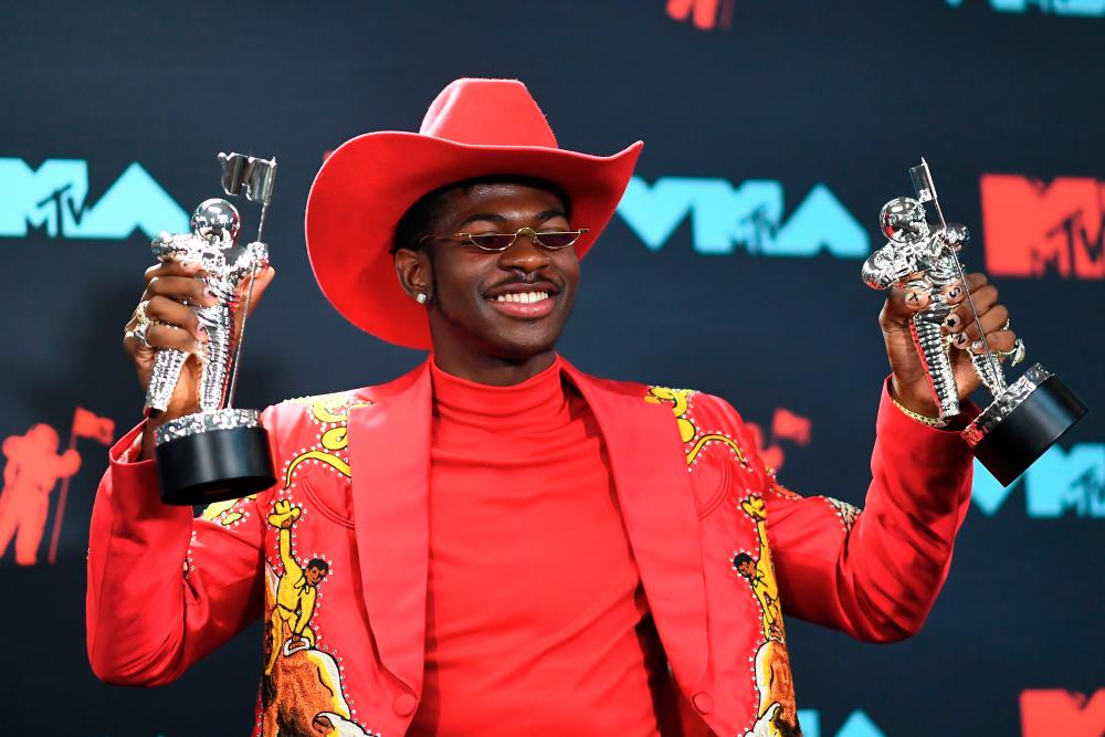 In this file photo taken on August 26, 2019 US rapper Lil Nas X poses with the Song of the Year Award in the press room during the 2019 MTV Video Music Awards at the Prudential Center in Newark, New Jersey. After his ouster from the Hot Country US song charts triggered outrage and catapulted him to overnight fame, genre-bending artist Lil Nas X is up for a Country Music Award. His now-ubiquitous record-breaking megahit “Old Town Road” –which marries twangy banjo with thumping bass– will compete for “Musical Event of the Year” at this year’s CMAs, organizers announced on August 28, 2019. / AFP / Johannes EISELE