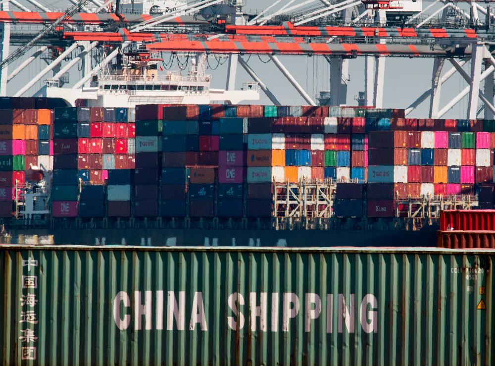 In this file photo taken on September 14, 2019 shipping containers from China and other Asian countries are unloaded at the Port of Los Angeles as the trade war continues between China and the US, in Long Beach, California. - AFP