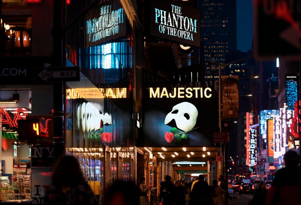 In this file photo signage of the Broadway play “The Phantom of the Opera” is seen at Time Square on March 12, 2020 in New York City. New York’s iconic Broadway theater district will stay closed through the end of the year, its trade association said June 29, 2020, due to the unpredictability of the coronavirus pandemic. The Broadway League did not set a date for performances to resume, but is offering refunds and exchanges for tickets purchased for all shows through January 3, 2021.