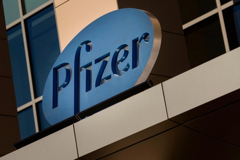 (FILES) In this file photo a sign for Pfizer pharmaceutical company is seen on a building in Cambridge, Massachusetts, on March 18, 2017. AFPpix