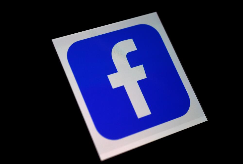 In this file illustration photo taken on March 25, 2020 a Facebook App logo is displayed on a smartphone in Arlington, Virginia. Facebook said on August 5, 2020 that it had removed a post from the page of US President Donald Trump over what it called “harmful Covid misinformation.” — AFP