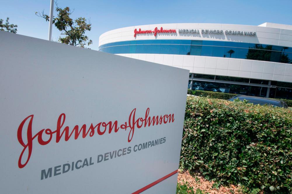 (FILES) In this file photo taken on August 28, 2019 an entry sign to the Johnson &amp; Johnson campus shows their logo in Irvine, California on August 28, 2019.- AFP