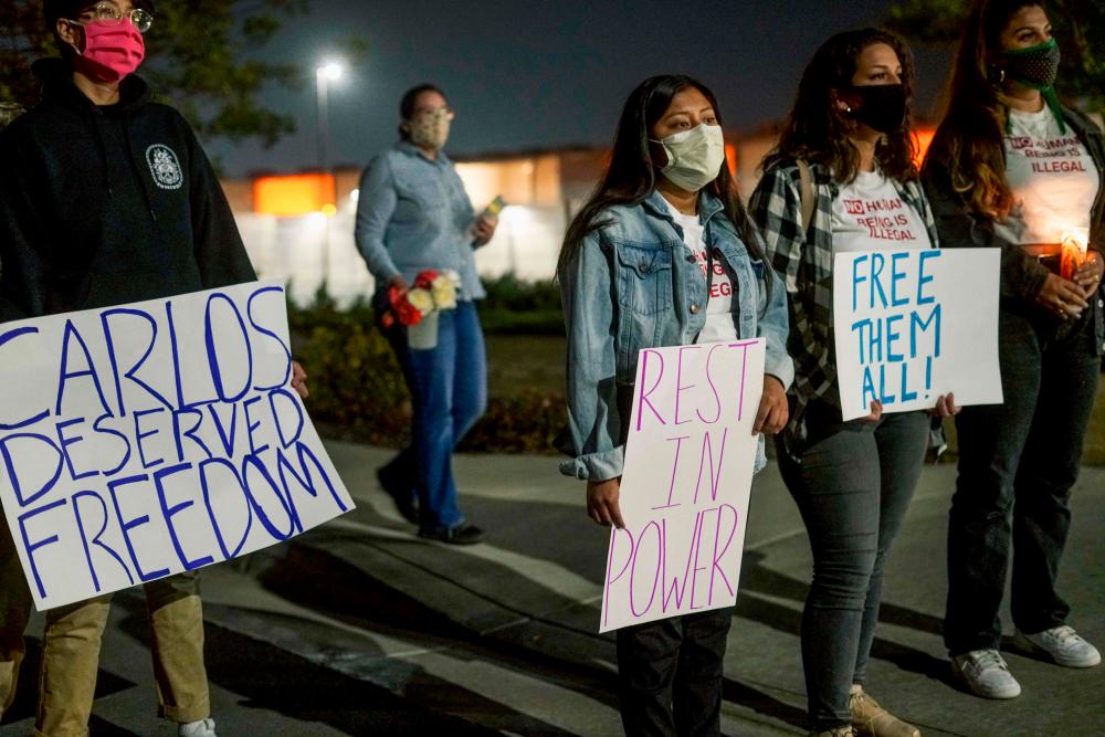In this file photo taken on May 9, 2020 protesters stand outside Otay Mesa Detention Center during a “Vigil for Carlos” rally in Otay Mesa, California, to commemorate Carlos Ernesto Escobar Mejia, the first illegal immigrant who died of Covid-19 related symptoms while being held at the detention Center. A 74-year-old immigrant who had pleaded to be released from a detention facility in California for fear of contracting Covid-19 died by suicide at the weekend, officials said on May 18, 2020. — AFP