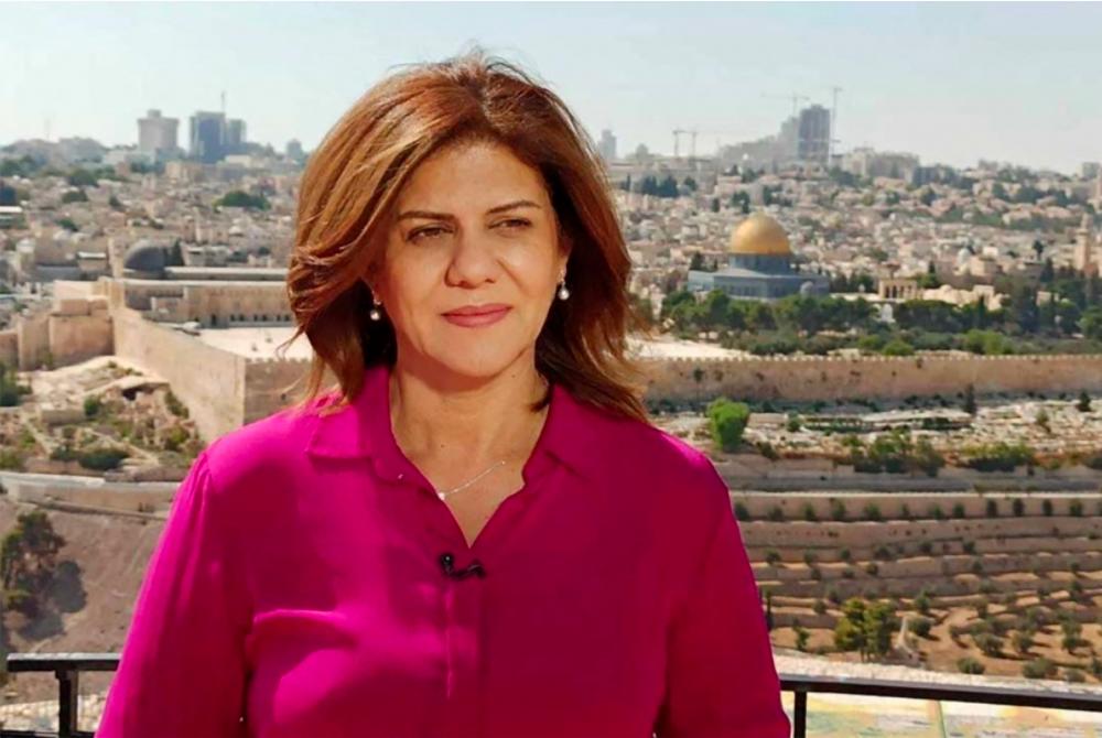 (FILES)This undated handout file photo released by the Doha-based Al-Jazeera TV, shows the channel's veteran journalist Shireen Abu Aqleh (Akleh) during one of her reports from Jerusalem. - AFPPIX
