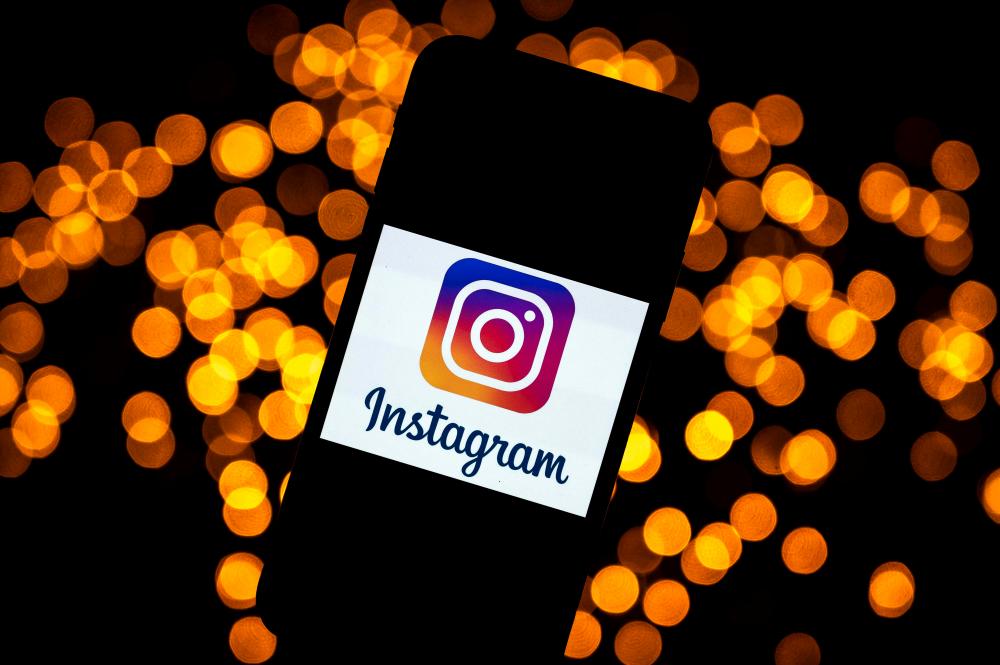 (FILES) This file picture taken on September 29, 2020 shows the logo of the social network Instagram on a smartphone, in Toulouse, southwestern France. - AFP