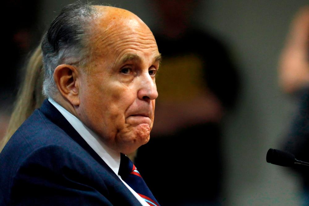 (FILES) In this file photo Rudy Giuliani, former personal lawyer of US President Donald Trump, looks on during an appearance before the Michigan House Oversight Committee in Lansing, Michigan on December 2, 2020. - AFP