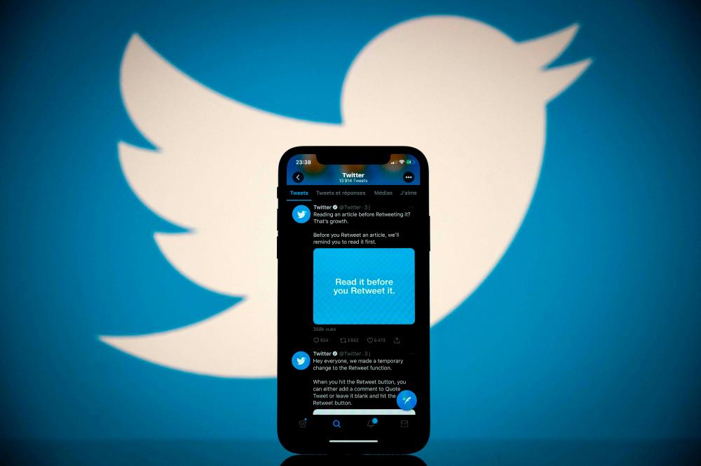 (FILES) In this file photo taken on October 26, 2020, this photograph shows the logo of US social network Twitter displayed on the screen of a smartphone and a tablet in Toulouse, southern France.-AFP