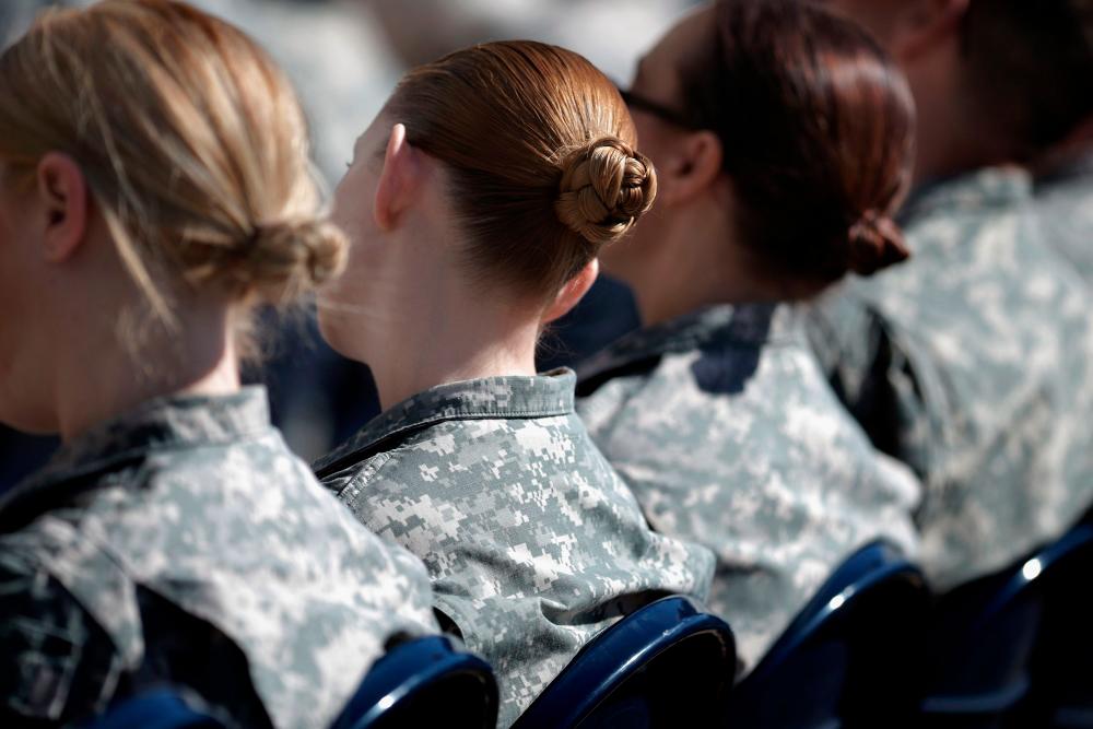 (FILES) In this file photo taken on March 31, 2015 soldiers, officers and civilian employees attend the commencement ceremony for the US Army’s annual observance of Sexual Assault Awareness and Prevention Month in the Pentagon Center Courtyard in Arlington, Virginia. Women in the US army are going to be able to dress up a little. The Pentagon announced on January 26, 2021 that female soldiers would be able to grow their hair long, color their nails and don earrings. / AFP / GETTY IMAGES NORTH AMERICA / CHIP SOMODEVILLA