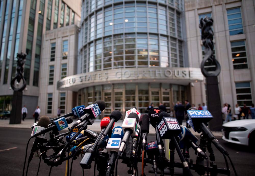 In this file photo taken on July 17, microphones are set up outside Brooklyn Federal Court for Mexican drug lord Joaquin El Chapo Guzman's sentencing, in New York. — AFP