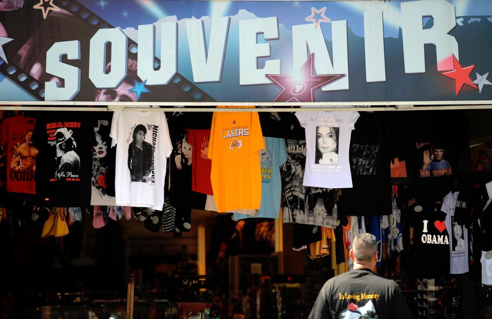 A man looks at Michael Jackson’s t-shirts for sale in a souvenir store in Hollywood, California. — AFP
