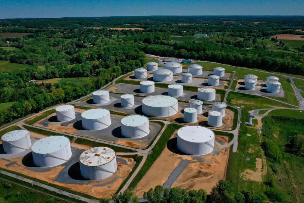 (FILES) In this file photo taken on May 13, 2021, in an aerial view, fuel holding tanks are seen at Colonial Pipeline's Dorsey Junction Station in Woodbine, Maryland. The US Justice Department announced on June 7, 2021 that it had recovered most of the $4.4 million paid by Colonial Pipeline to Russia-based ransomware extortionists Darkside who had forced the shutdown of a major US fuel network. – AFP