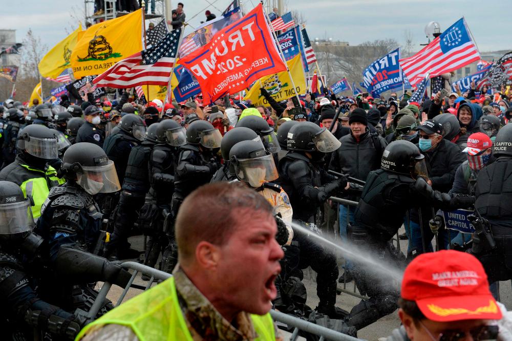 In this file photo taken on January 06, 2021, Trump supporters battle with police and security forces as they storm the US Capitol building in Washington, DC. AFPPIX
