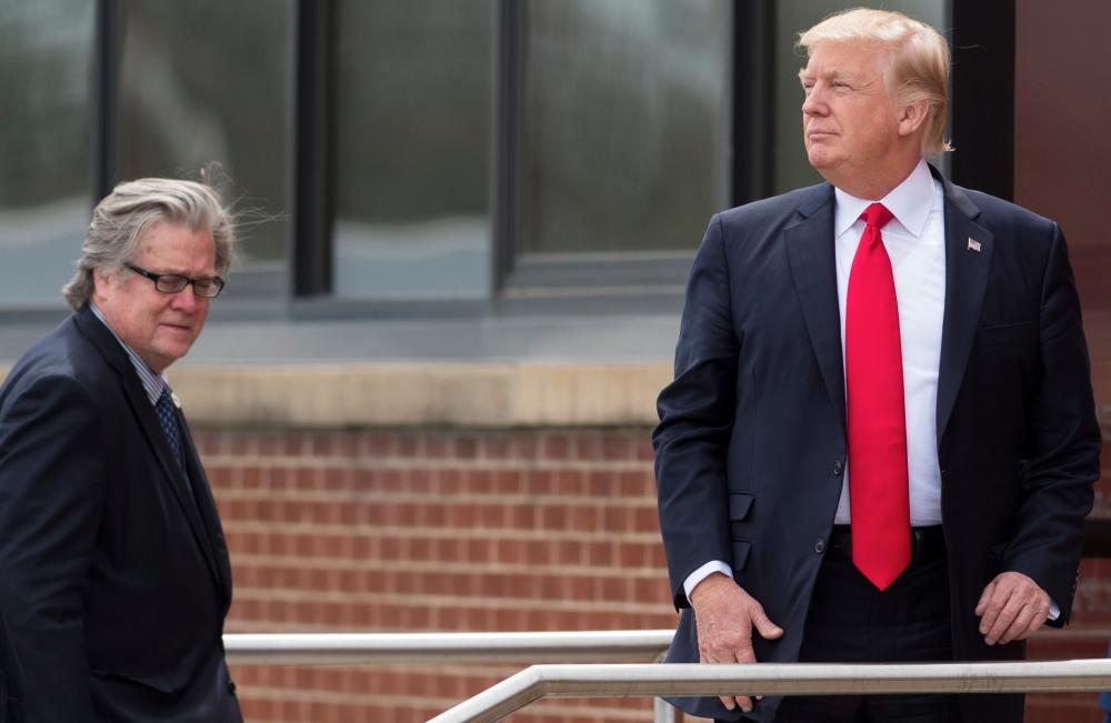 (FILES) In this file photo taken on April 18, 2017 US President Donald Trump stands alongside Chief Strategist Stephen Bannon (L) upon arrival at Snap-On Tools in Kenosha, Wisconsin, prior to signing the Buy American, Hire American Executive Order. AFP / SAUL LOEB