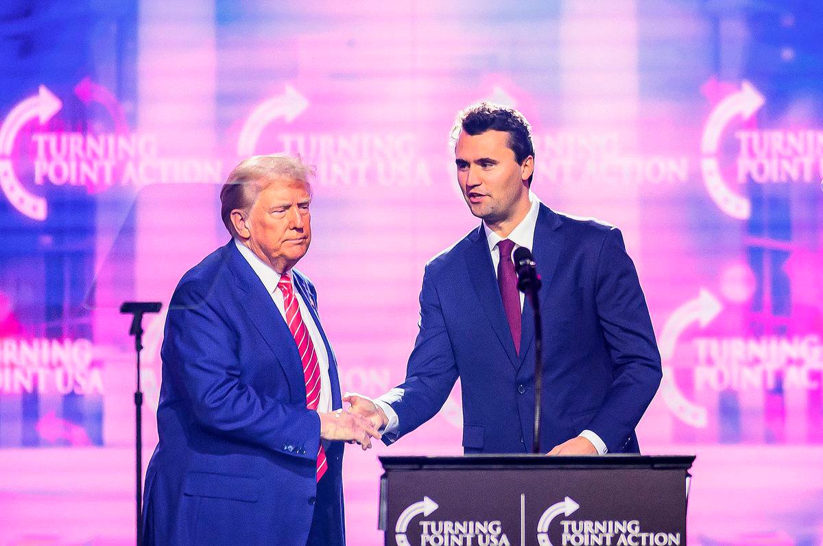 Right-wing activist Charlie Kirk (R) speaks on stage with President Donald Trump at America Fest 2024 in Phoenix, Arizona, on December 22, 2024. Photo by JOSH EDELSON / AFP