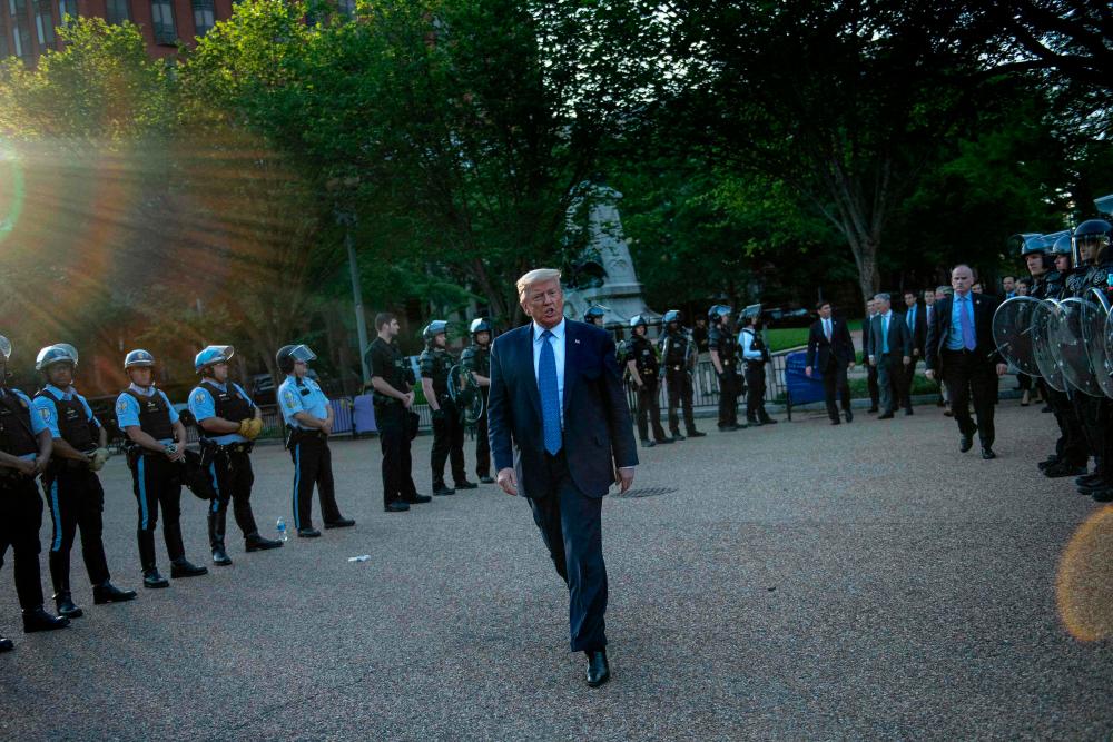 (FILES) In this file photo taken on June 1, 2020 US President Donald Trump leaves the White House on foot to go to St John's Episcopal church across Lafayette Park in Washington, DC. – AFP