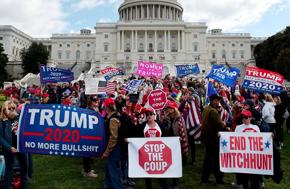 In this file photo taken on Oct 16, supporters of US President Donald Trump hold a Stop Impeachment rally in front of the US Capitol in Washington, DC. — AFP