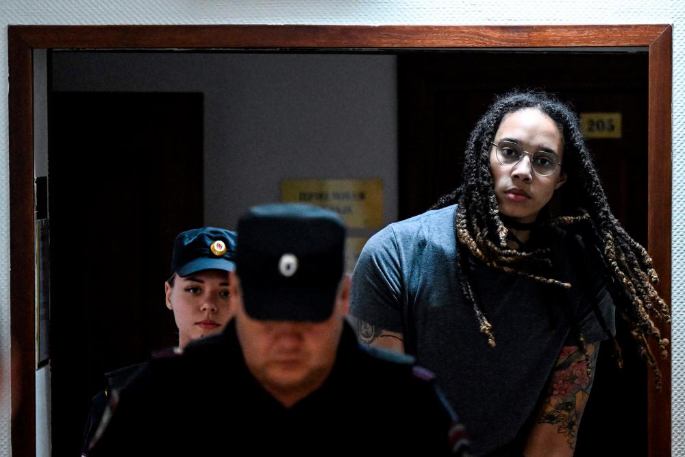 (FILES) In this file photo taken on August 04, 2022 US Women National Basketball Association’s (WNBA) basketball player Brittney Griner, who was detained at Moscow’s Sheremetyevo airport and later charged with illegal possession of cannabis, is escorted to the courtroom to hear the court’s final decision in Khimki outside Moscow. AFPPIX