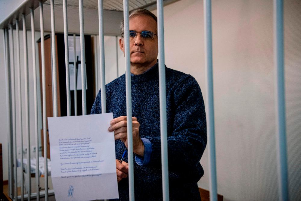 US-British Paul Whelan, a former US Marine accused of espionage and arrested in Russia in December 2018, holds a message as he stands inside a defendants’ cage before a hearing to decide to extend his detention at the Lefortovo Court in Moscow on October 24, 2019/AFPPix