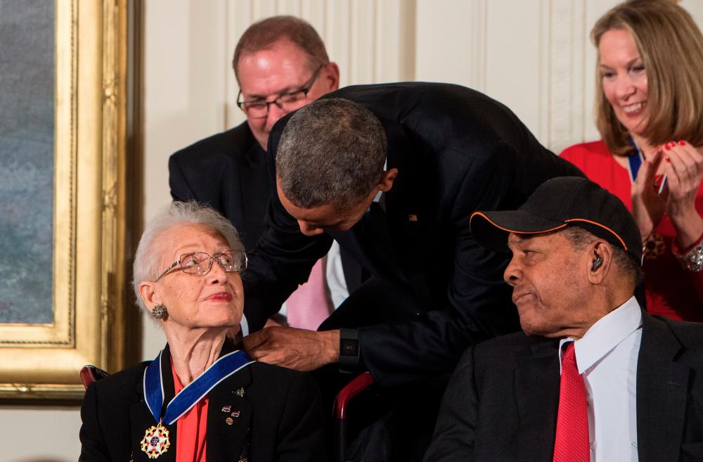 In this file photo taken on November 24, 2015 former US President Barack Obama presents the Presidential Medal of Freedom to NASA mathematician and physicist Katherine Johnson at the White House in Washington, DC. Katherine Johnson, whose calculations enabled Apollo 11 to land on the moon, died on February 24, 2020 at 101. Her story was told in the film “Hidden Figures.” / AFP / Nicholas KAMM