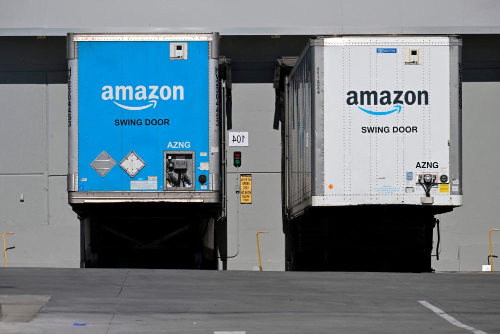 Freight semi trailers are docked at the Amazon warehouse in Palmdale, California. Amazon reported a quarterly profit that trounced market expectations, driven by its e-commerce and cloud computing units. – AFPpic