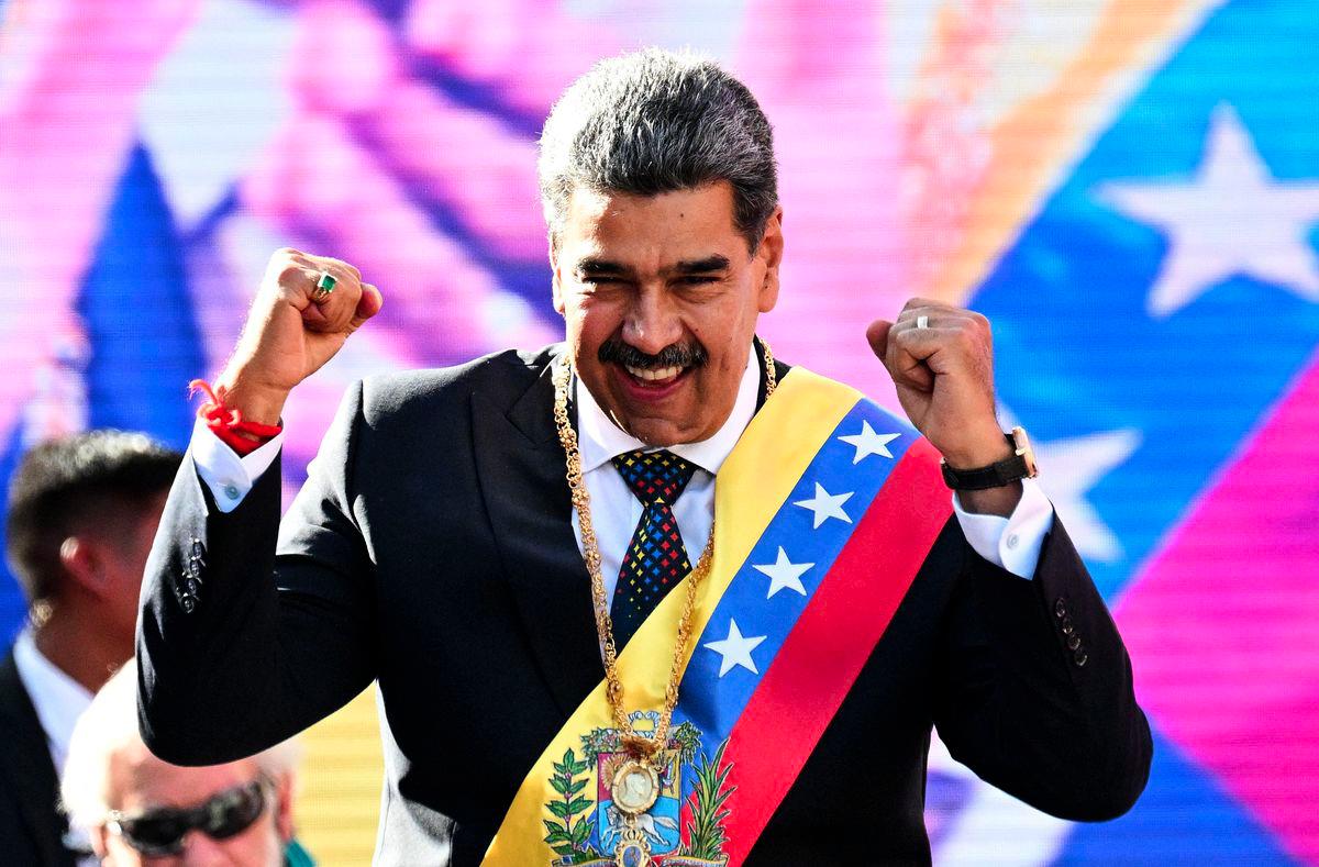 Venezuela's President Nicolas Maduro gestures to supporters after delivering a speech in front of Miraflores presidential palace in Caracas on January 10, 2025. - AFPPIX