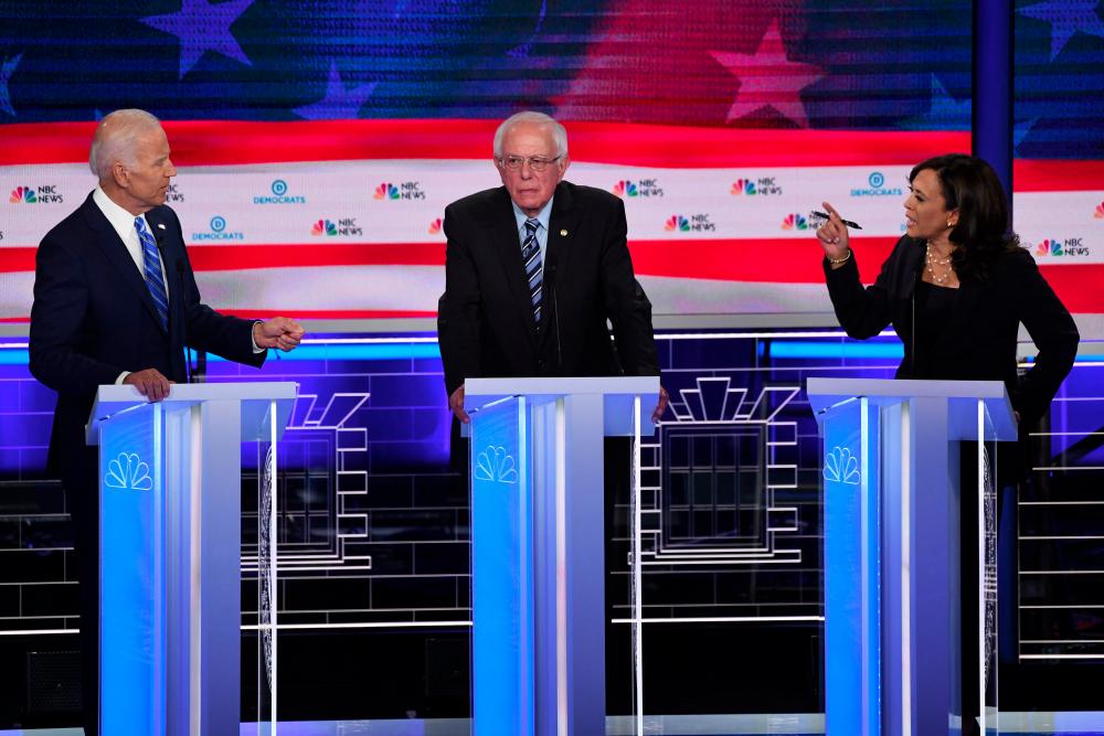 In this file photo taken on June 27, 2019 Democratic presidential hopefuls (from L) former US Vice President Joseph R. Biden Jr., US Senator for Vermont Bernie Sanders and US Senator for California Kamala Harris speak during the second Democratic primary debate of the 2020 presidential campaign season hosted by NBC News at the Adrienne Arsht Center for the Performing Arts in Miami, Florida. — AFP
