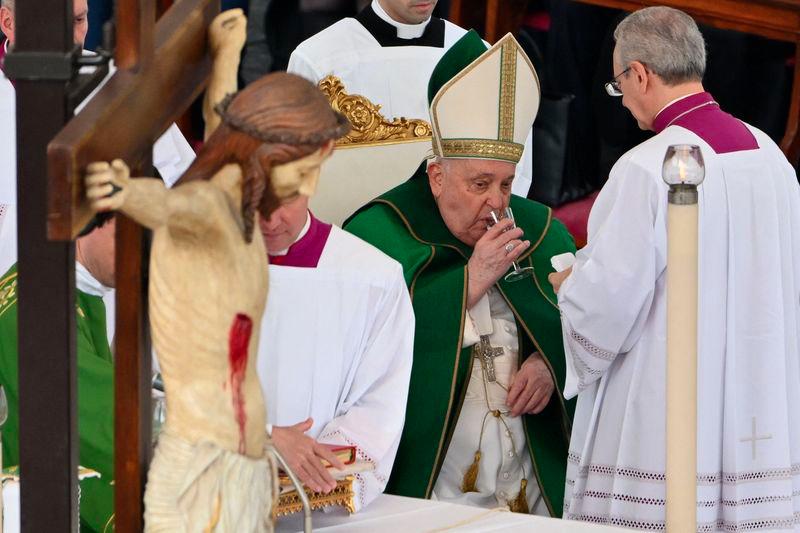 Pope Francis drinks as he celebrates a mass for the Jubilee of the Armed Forces at St. Peter's square in the Vatican on February 9, 2025. - AFPPIX