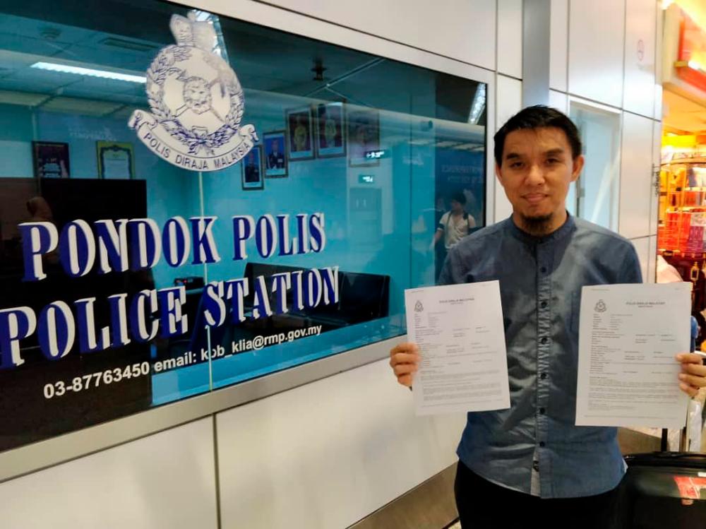 Firdaus Wong Wai Hung with the police reports, at the KLIA police booth, on April 14, 2019. — Pix from Firdaus Wong Wai Hung Facebook.