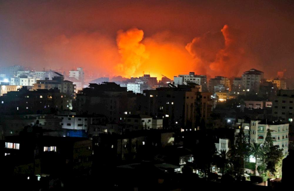 Fire erupts from the Andalus Tower as it is destroyed by an Israeli airstrike in Gaza City, controlled by the Palestinian Hamas movement, early on May 16, 2021. — AFP