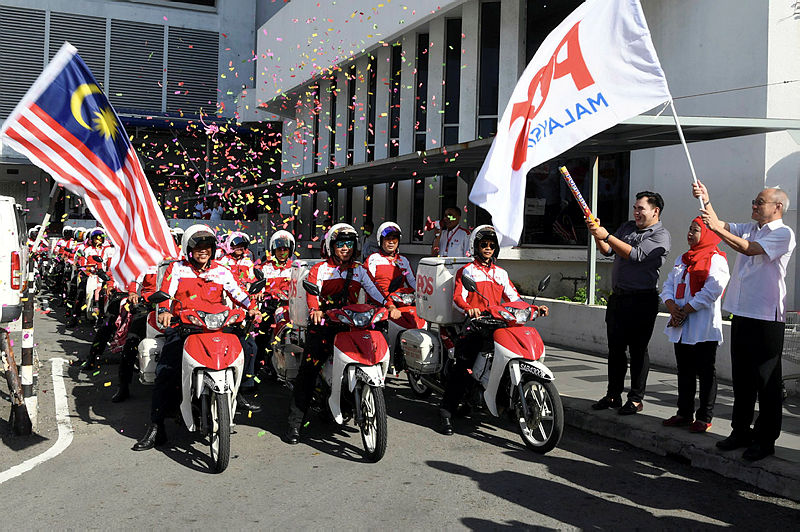 Postmen are flagged off during an occasion to mark the World Post Day celebration, on Oct 9, 2019. — Bernama