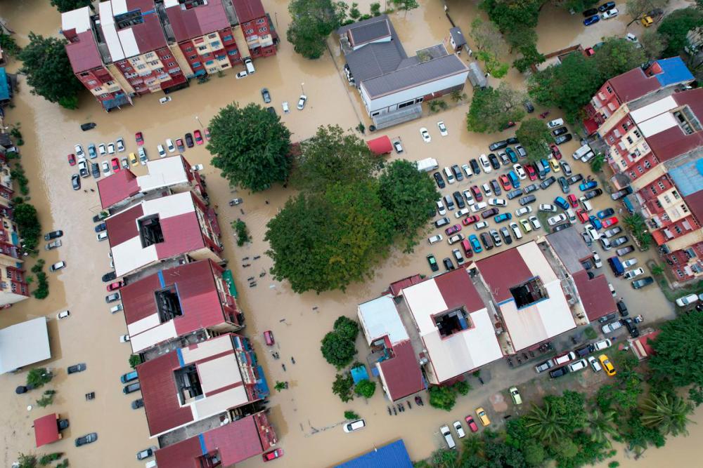 A view of buildings and vehicles submerged in flood waters in Shah Alam, Selangor state, Malaysia, December 19, 2021. Picture taken with a drone. REUTERSPix