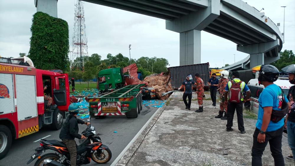 Container falls off flyover, smashes into two lorries