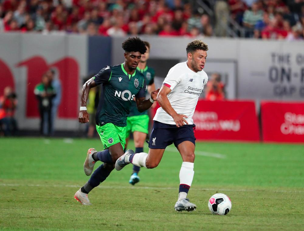 Alex Oxlade-Chamberlain #15 of Liverpool and Therry Correia #50 of Sporting CP battle for the ball during their Pre Season friendly match at Yankee Stadium on July 24, 2019 in New York City. — AFP