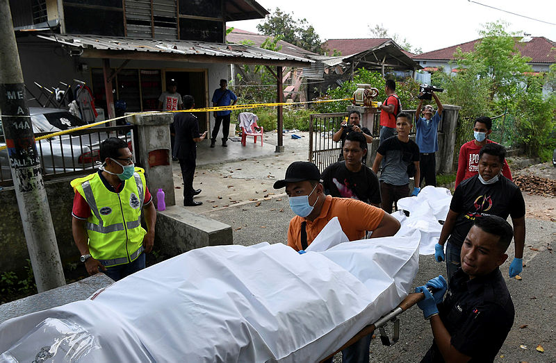Officers from the forensics department bring out the remains of the couple, on April 15, 2019. — Bernama