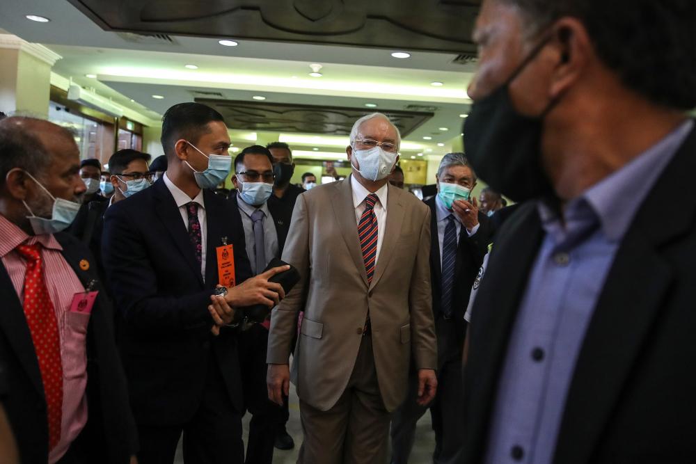 Former prime minister Datuk Seri Najib Abdul Razak (C) arrives at the Kuala Lumpur High Court complex in Kuala Lumpur earlier today. - EPA